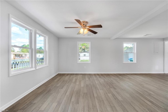 empty room with light wood-style floors, a healthy amount of sunlight, ceiling fan, and baseboards
