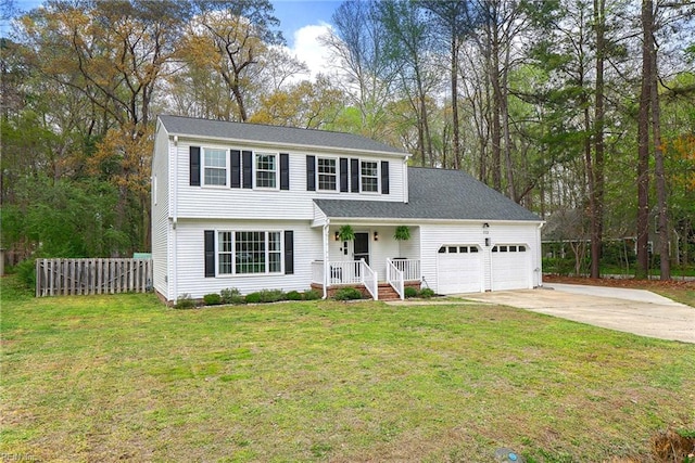 view of front of property with an attached garage, driveway, fence, and a front lawn