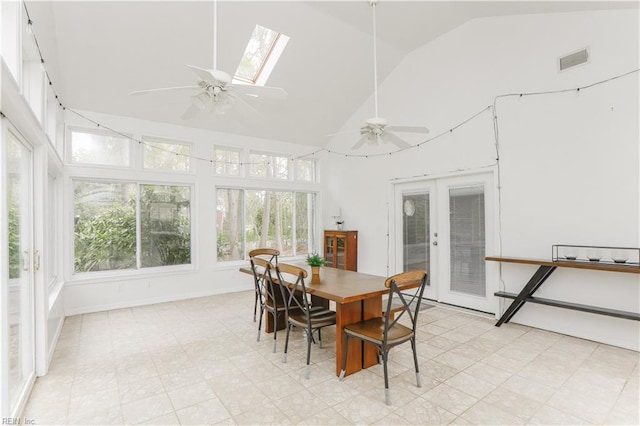 sunroom / solarium with high vaulted ceiling, french doors, visible vents, and a skylight