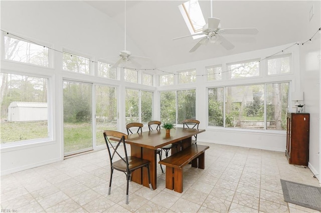 sunroom featuring high vaulted ceiling, plenty of natural light, and baseboards