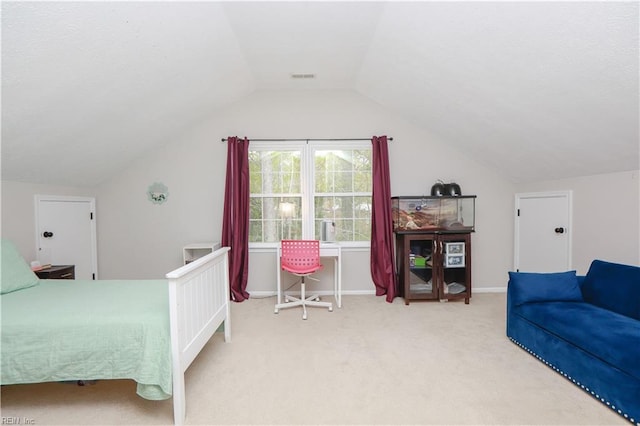 bedroom featuring carpet and lofted ceiling