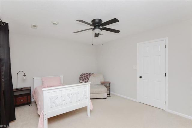 carpeted bedroom with baseboards, a ceiling fan, and visible vents