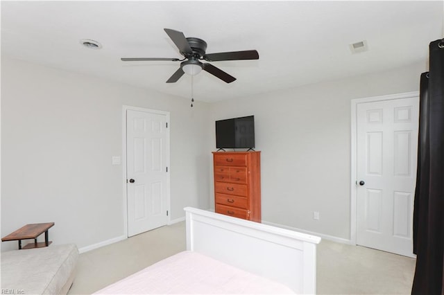 bedroom with visible vents, baseboards, ceiling fan, and light carpet