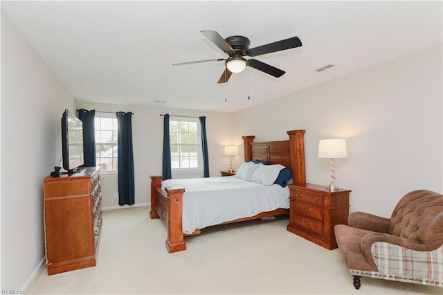 bedroom featuring light carpet, baseboards, a ceiling fan, and visible vents