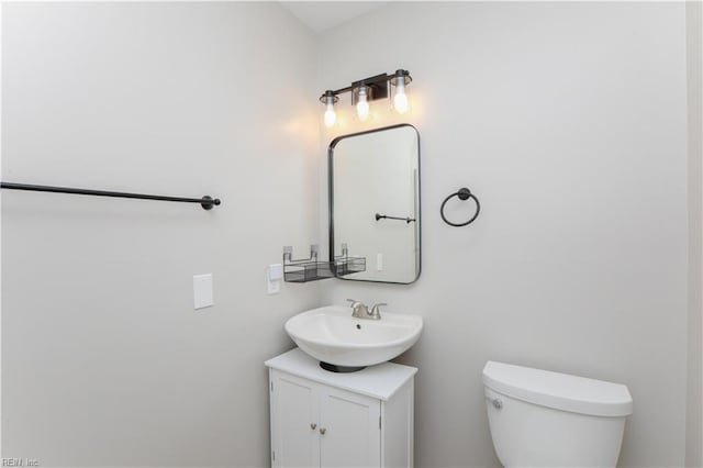 bathroom with toilet and vanity