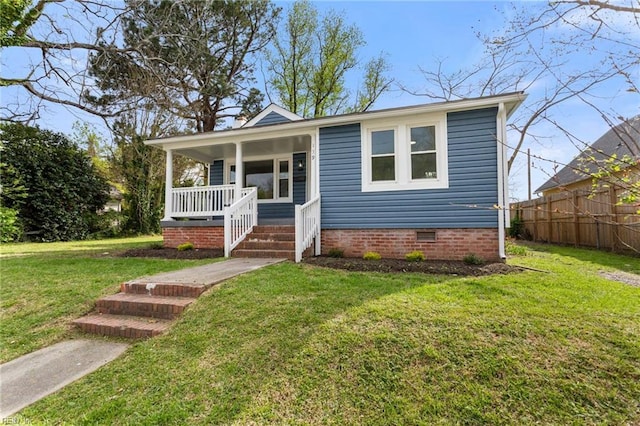139 Ash Ave, Newport News, VA 23607 - bungalow-style house with a porch, a front yard, fence, and crawl space