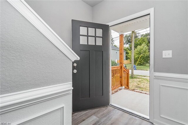 731 33rd St, Newport News, VA 23607 - foyer entrance featuring wood finished floors, a textured wall, and wainscoting