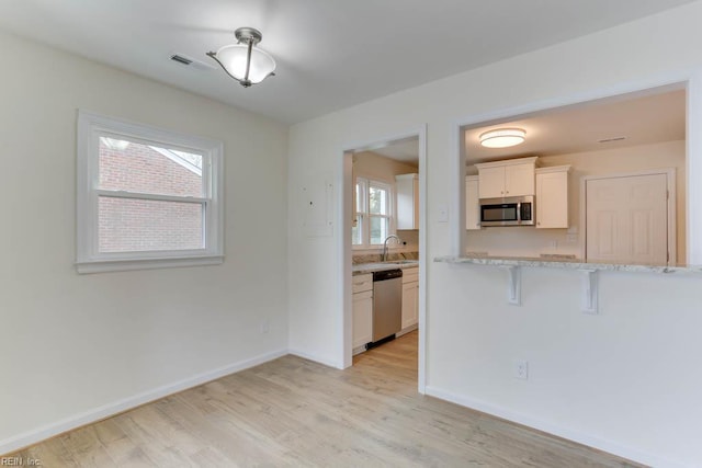 1793 Old Buckroe Rd, Hampton, VA 23664 - kitchen featuring a sink, light wood-style flooring, plenty of natural light, and stainless steel appliances