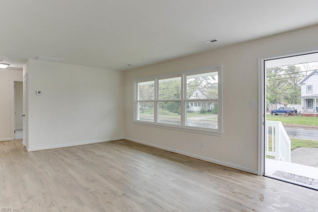1793 Old Buckroe Rd, Hampton, VA 23664 - unfurnished living room with visible vents, baseboards, and light wood finished floors