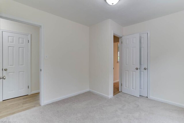 1793 Old Buckroe Rd, Hampton, VA 23664 - unfurnished bedroom with baseboards and light carpet