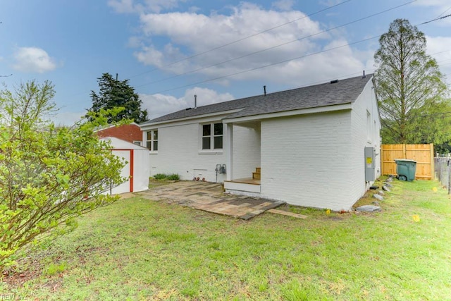 1793 Old Buckroe Rd, Hampton, VA 23664 - rear view of property with an outbuilding, a patio area, a yard, fence, and brick siding