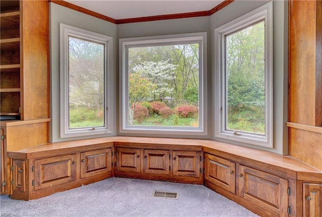interior space featuring light carpet, ornamental molding, and visible vents
