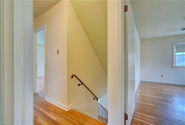 stairs featuring wood finished floors and baseboards