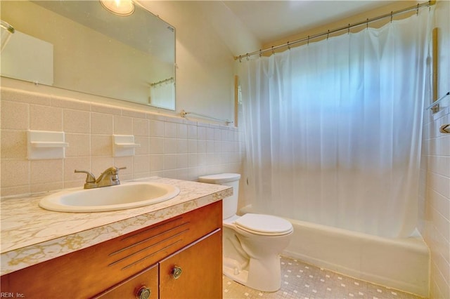bathroom featuring vanity, shower / bath combo, tile patterned floors, toilet, and tile walls