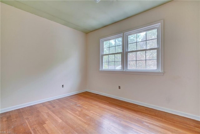 unfurnished room featuring light wood-style flooring and baseboards