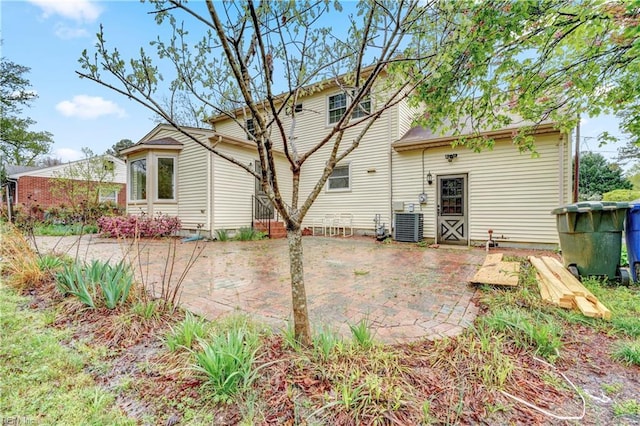 rear view of house featuring cooling unit and a patio