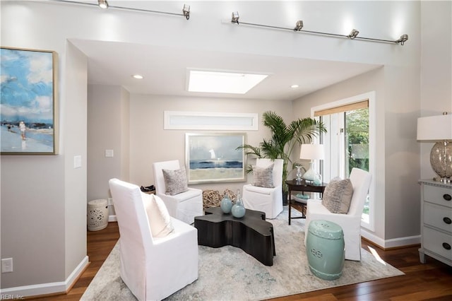 living area with wood finished floors, baseboards, and recessed lighting