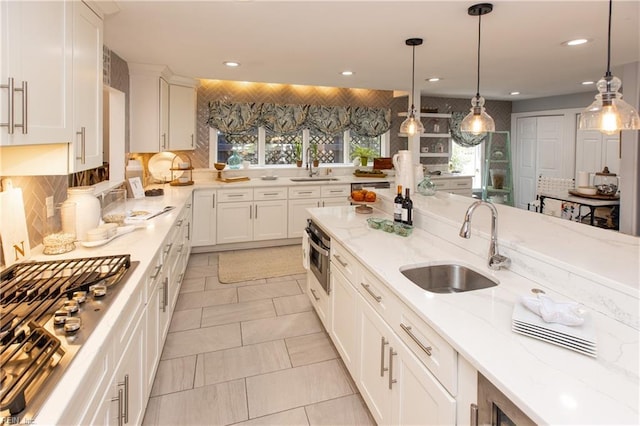 kitchen featuring a sink, backsplash, and recessed lighting