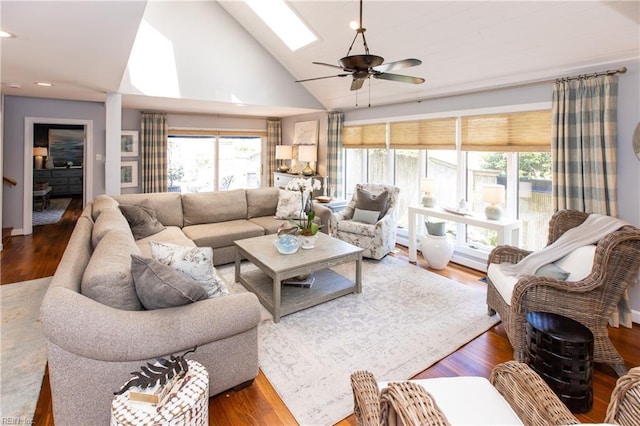 living room featuring a skylight, recessed lighting, ceiling fan, high vaulted ceiling, and wood finished floors