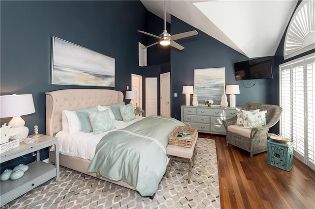 bedroom with multiple windows, vaulted ceiling, a ceiling fan, and wood finished floors