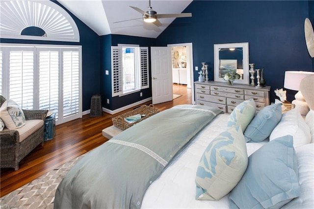 bedroom featuring ceiling fan, baseboards, wood finished floors, and lofted ceiling