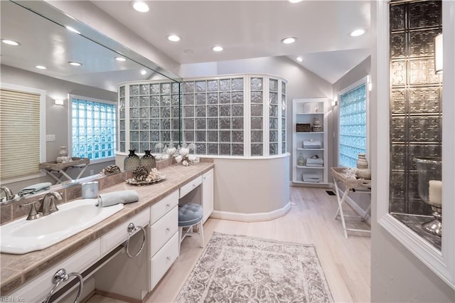 full bathroom featuring wood finished floors, vanity, and recessed lighting