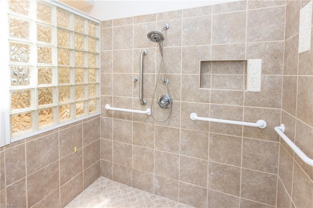 bathroom with tiled shower