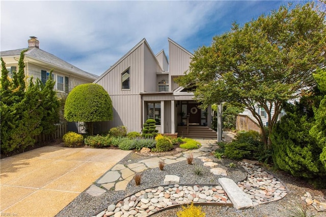 exterior space featuring board and batten siding and fence