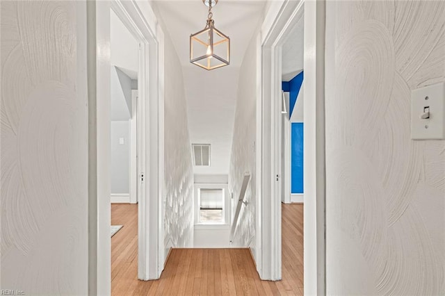 hallway with light wood-type flooring and visible vents