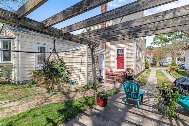 view of patio with entry steps and a pergola