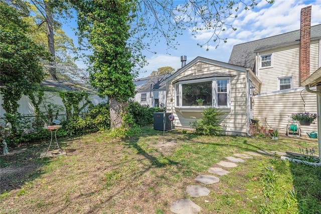 view of yard with fence and central AC unit