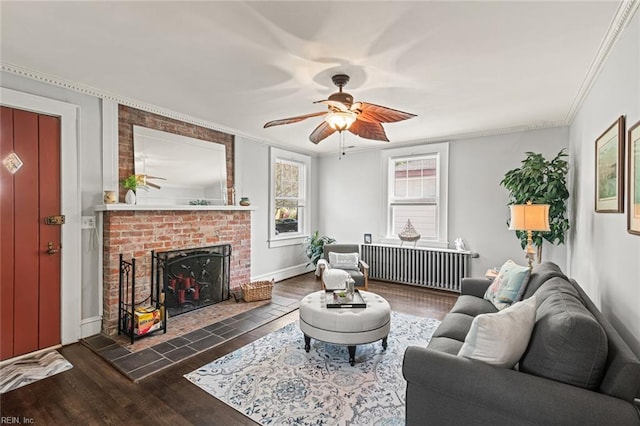 living room featuring ornamental molding, radiator heating unit, and wood finished floors