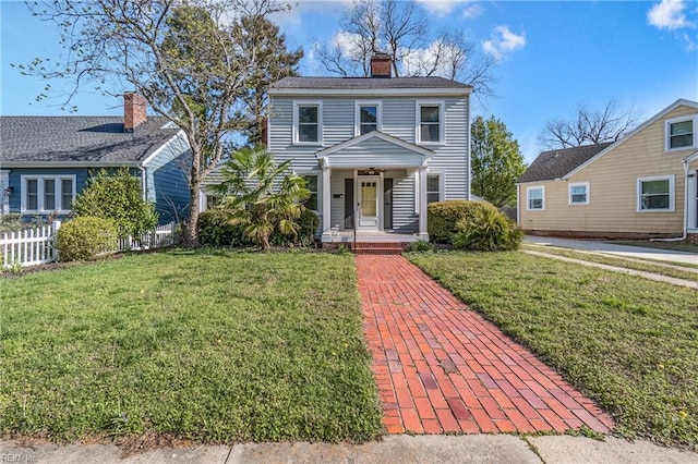 view of front of home with a front lawn, fence, and a chimney