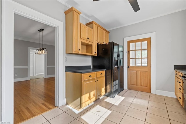 kitchen with ornamental molding, black refrigerator with ice dispenser, light tile patterned flooring, dark countertops, and baseboards