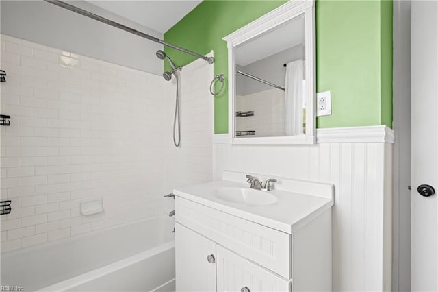 full bathroom with tub / shower combination, wainscoting, and vanity