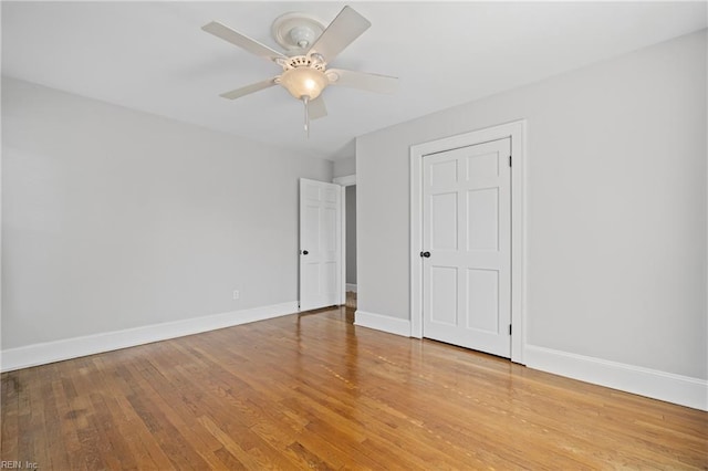 unfurnished bedroom featuring wood finished floors, ceiling fan, and baseboards
