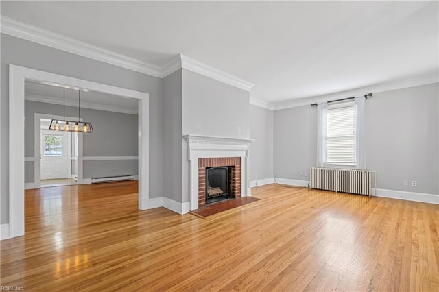 unfurnished living room with baseboards, light wood-type flooring, a fireplace, radiator, and a baseboard heating unit