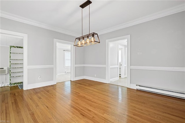unfurnished dining area featuring ornamental molding, wood finished floors, a baseboard heating unit, a notable chandelier, and baseboards