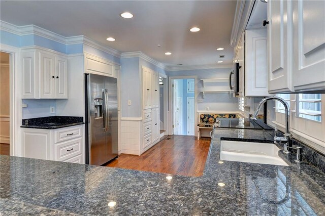 kitchen with white cabinetry, recessed lighting, dark stone countertops, appliances with stainless steel finishes, and a sink