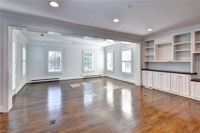 unfurnished living room featuring a baseboard heating unit, ornamental molding, and dark wood finished floors