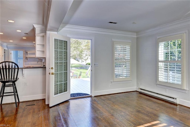 doorway featuring visible vents, a baseboard radiator, and a wealth of natural light