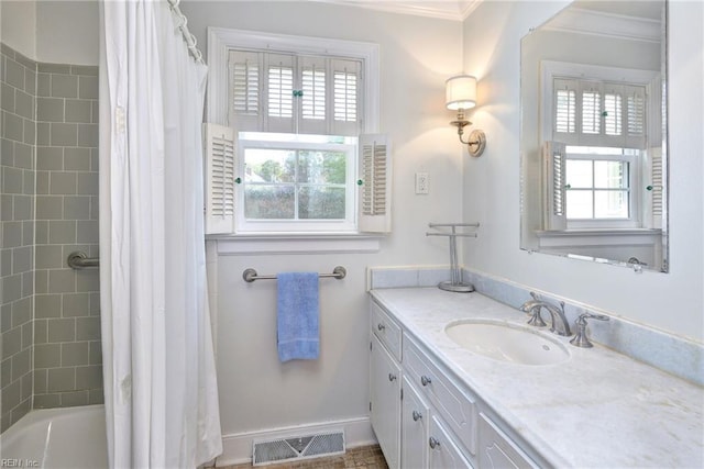 bathroom with vanity, ornamental molding, and visible vents
