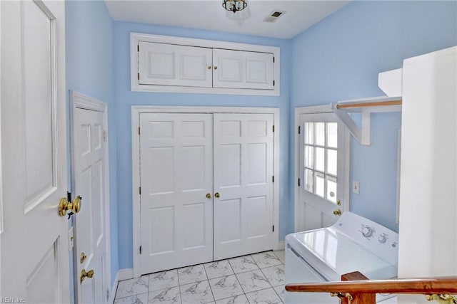 entryway with washer / clothes dryer, marble finish floor, and visible vents