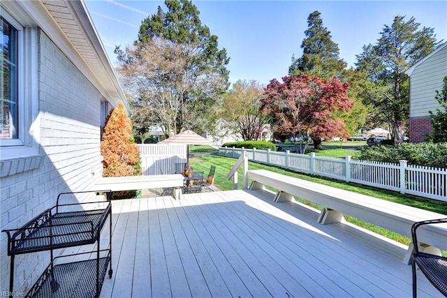 wooden deck with fence and a lawn