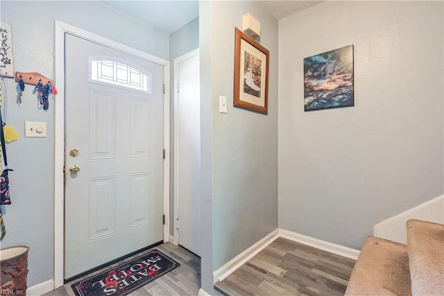 entryway featuring baseboards and wood finished floors