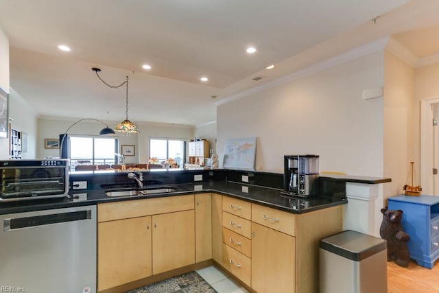 kitchen with dark countertops, dishwasher, light brown cabinets, a sink, and crown molding
