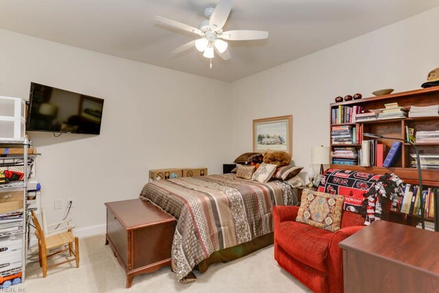 bedroom featuring baseboards, light colored carpet, and ceiling fan