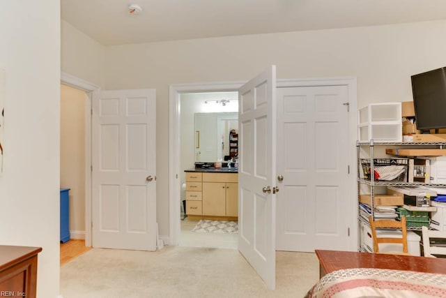 bedroom featuring light carpet
