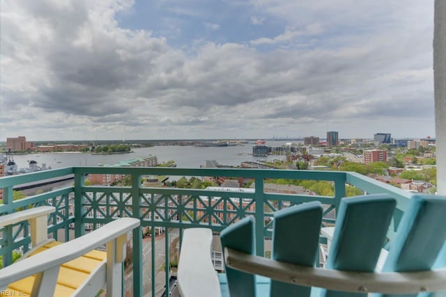 balcony featuring a city view and a water view
