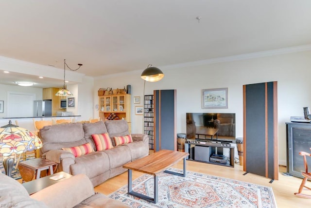 living room with light wood-type flooring, recessed lighting, and crown molding